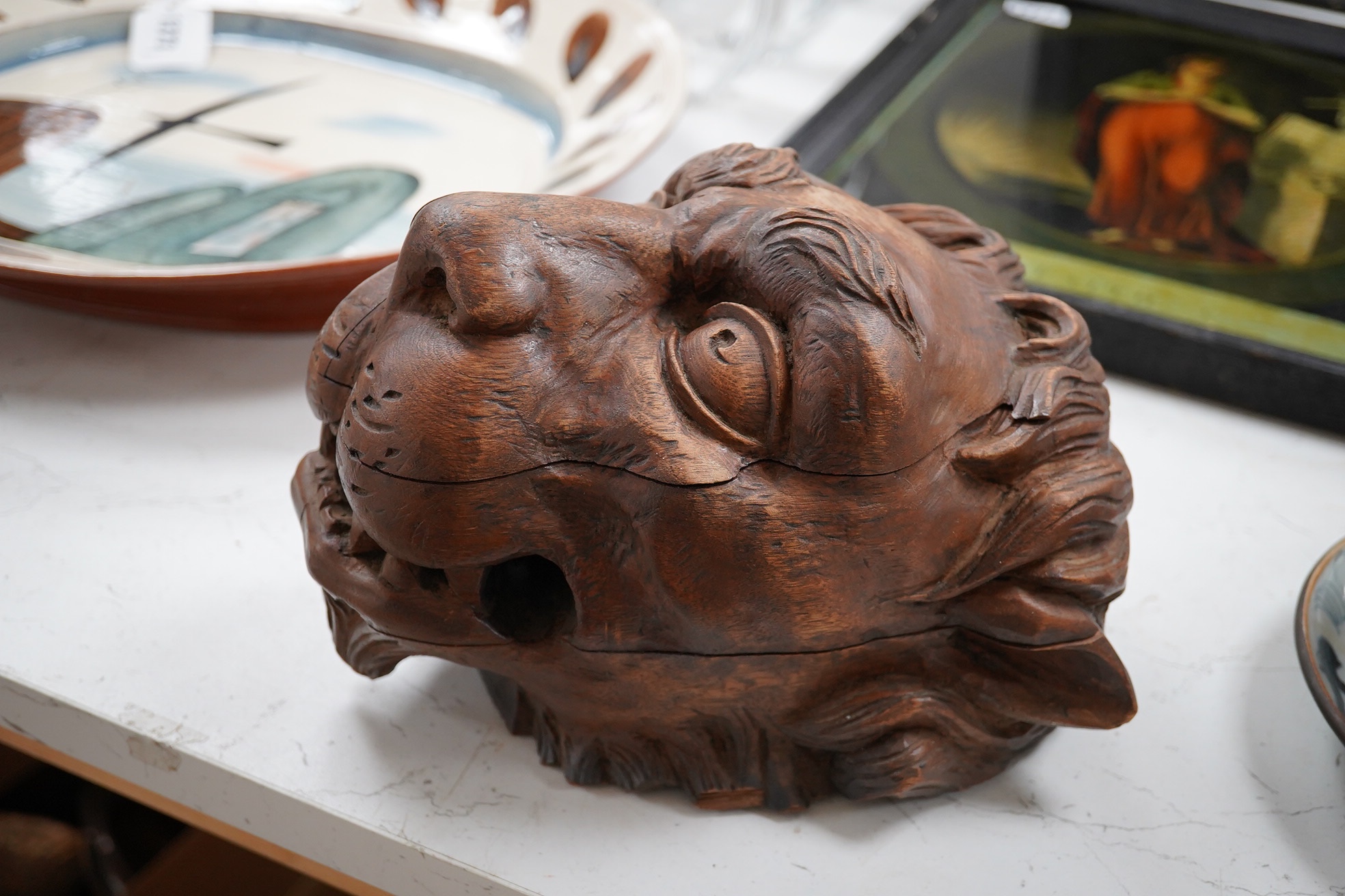 An 19th century carved 'Lion's head' corbel, 21cm high. Condition - poor